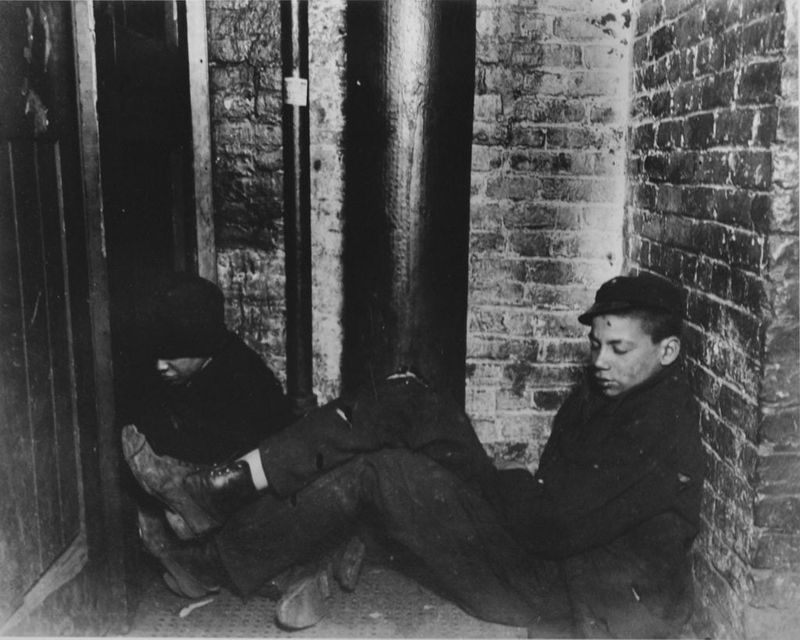 A couple of newsboys catch some shuteye in The Sun newspaper building, 1892